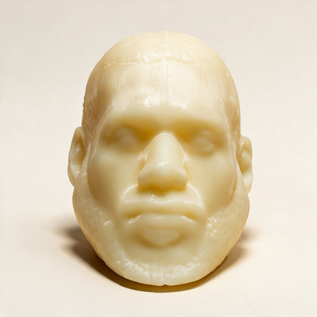 LeSoap Honey sculpted head soap, front view on a cream background